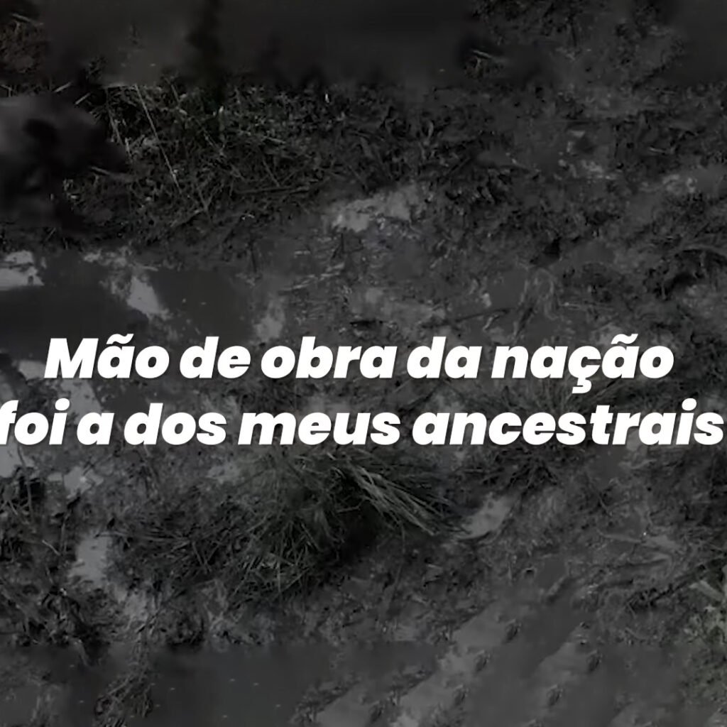 Print do Lyric Video da Música 'Igualdade/Equidade - 20 de Novembro' com destaque para frase 'Mão de obra da nação foi a dos meus ancestrais'.